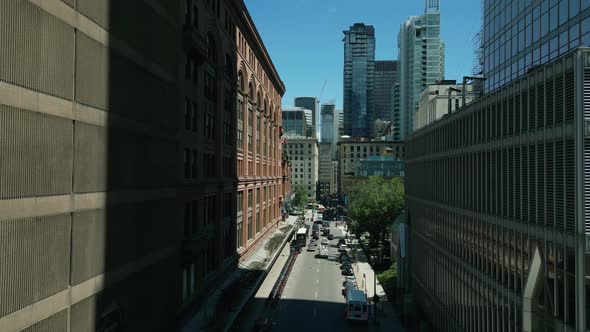 4K Cinematic urban drone footage of an aerial view of a boulevard in the middle of downtown Montreal