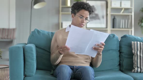 Cheerful Young African Girl Going Through Notes