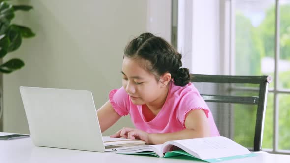 A girl studying online distance learning while quarantine at home.