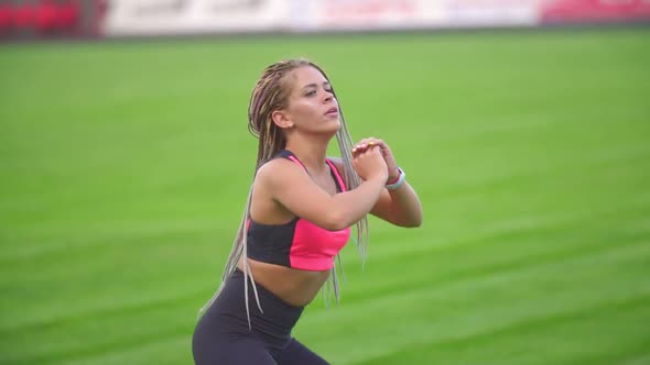 Girl Exercising at the Stadium