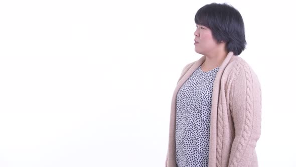 Happy Overweight Asian Woman Touching Something and Ready for Winter