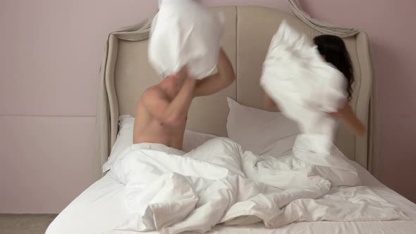 Couple Fighting By Pillows.