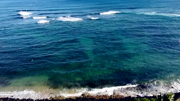 Drone shot. Pacific ocean shore push over waves. 1080p 24fps.