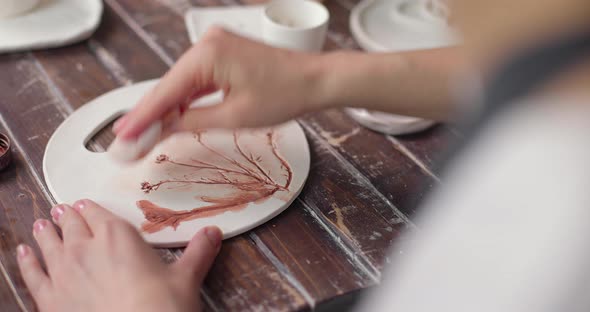 Artist Creates a Beautiful Pattern on Earthenware in a Pottery Workshop