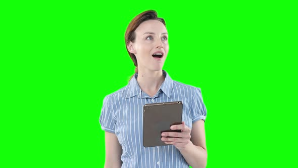 Caucasian woman using a digital tablet on green background