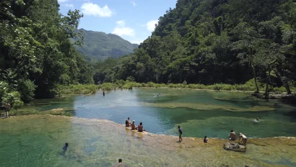 AERIAL: People in Semuc Champey waterfalls in Guatemala