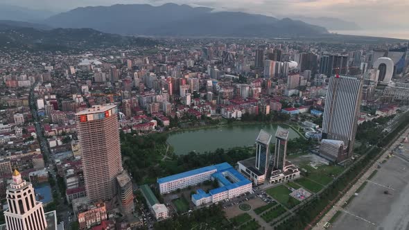 Top aerial view of beautiful lake in the center of Batumi at sunset. flying over 6 May park