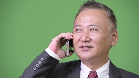 Mature Japanese Businessman Using Phone