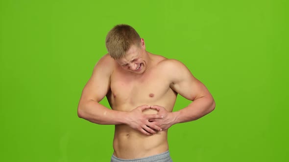 Man Makes Massage in His Sore Left Side. Green Screen