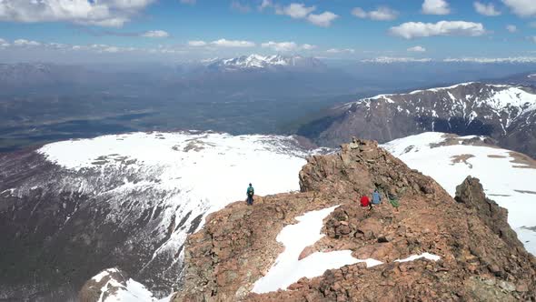 Aerial orbital of a group of people resting and enjoyig the view at the top of Perito Moreno Hill, E