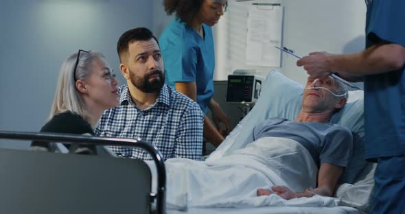 Patient Lying in Hospital Among Visitors