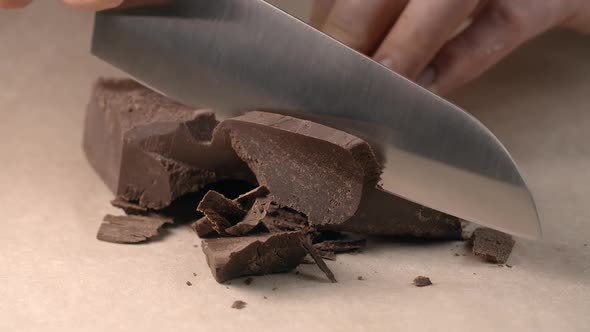 Chef Chops of Small Pieces of Chocolate By Knife in Slow Motion, Cooking with Chocolate, Sweet