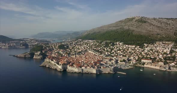 Aerial footage of Dubrovnik old town. Wide shot showing all of the ancient city, slowly pushing in t