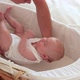 Mother putting baby in bassinet - VideoHive Item for Sale