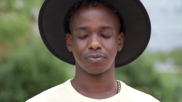 Young African Hipster Man Smiling on Camera Outdoor at City Park