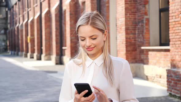 Happily Smiling Attractive Woman Standing on the Street