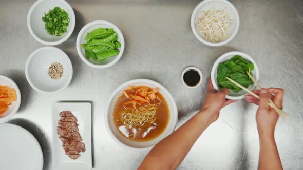 Overhead View of Making Traditional Asian Vegetable and Meat Noodle Soup From Scratch