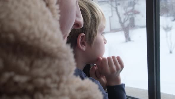 Kid looking through window.