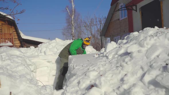 Man Shoveling Snow After Snow Storm