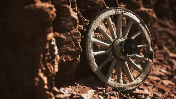 Old Wooden Cart Wheel on Stone Rocks