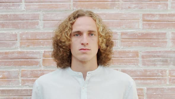 Portrait of a Serious Blond Caucasian Young Millennial Man Looking at Camera