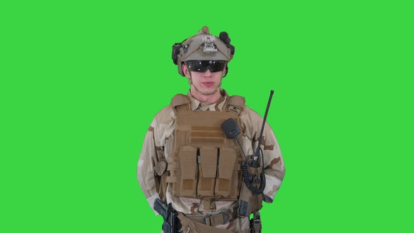 US Military Soldier in Uniform Reports on a Green Screen, Chroma Key.