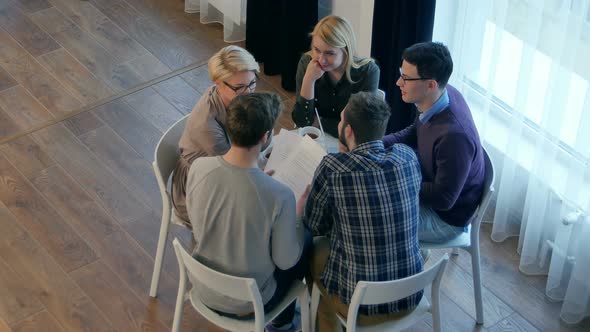 Team Communication Group of Five People Discussing Something with Smile While Sitting at the Office