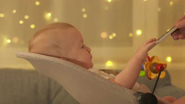 Father Giving Tv Remote to Child to Calm Him Down Happy Kid Sitting in Rocking Chair Watching TV at