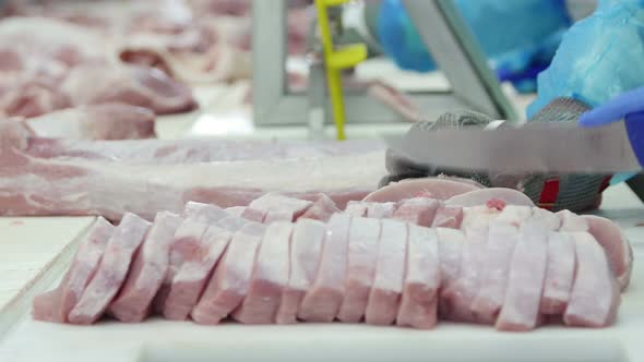 Butcher Who Cuts Meat In A Meat Processing Factory