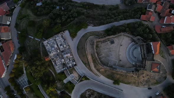 A drone pans over in a satellite birds-eye view of Belmont Castle showing the nearby town.