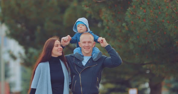 Dad Bears His Son on His Shoulders