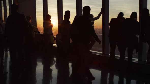 People inside a room at sunset time