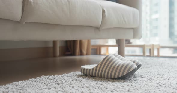 Woman wearing slipper at home