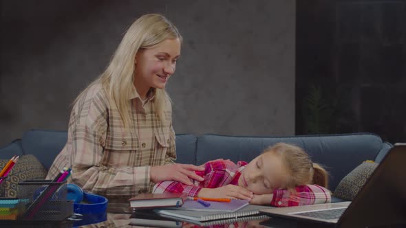 Caring Mom Waking Up Sleeping Schoolgirl at Home