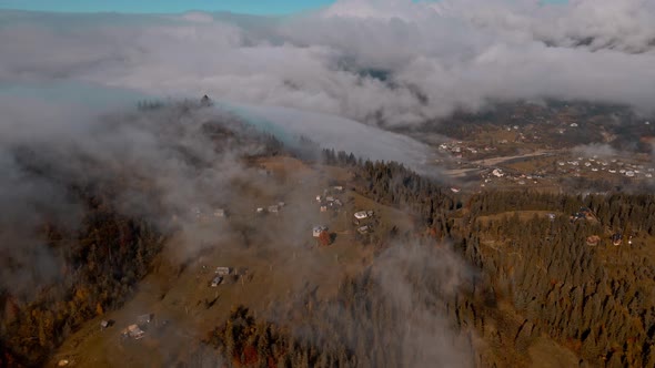 Aerial Bird Eye View of Houses in Mountain Village Arrounded Spruce Forest on Mountain Hills at