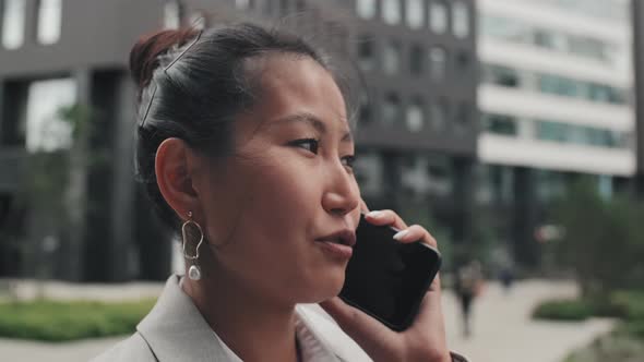 Cheerful Businesswoman Talking on Phone Outside