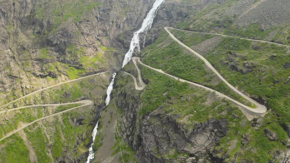 Narrow Road Of Trollstigen Along  With The Stigfossen Waterfall In More Og Romsdal, Norway. aerial