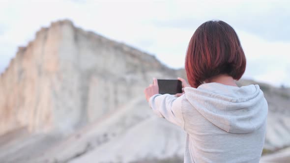 Traveler Woman Shooting a Video of White Rock Crimea