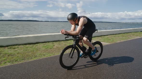 An Hardy Triathlete Rides a Bike Pro Cyclist Rides on the Road Athlete Trains on a Cutting Bike