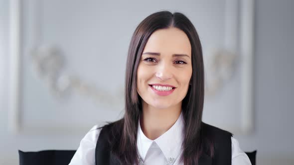 Portrait of Beautiful Young Smiling Brunette Businesswoman Posing and Looking at Camera