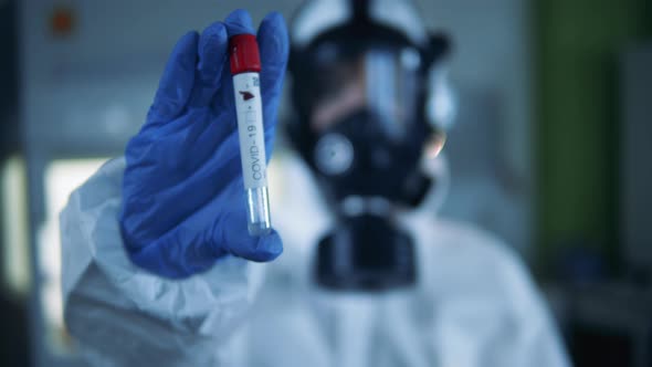 Scientist Holds a Tube with Coronavirus Vaccine.