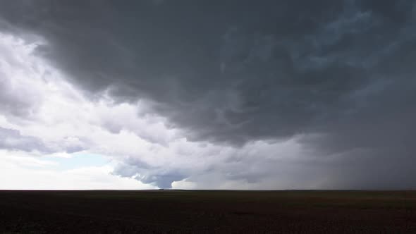 Wide view of storm as tornado quickly touches down in the distance