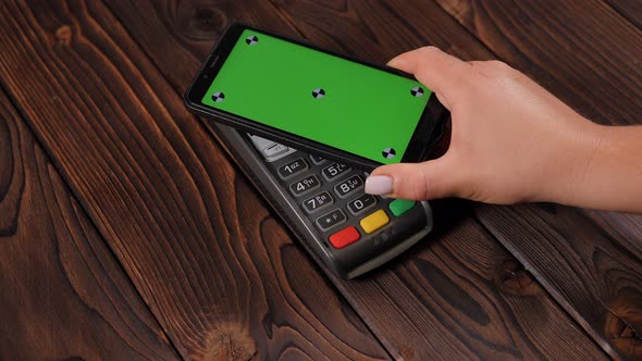 Closeup a Smartphone with Green Screen Template with an NFC Payment Technology