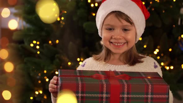 Girl Opens Box with Light Surprised and Happy