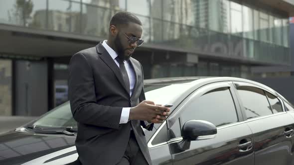 Rich Afro-American Man Waiting for Partners Near Office Building to Do Business