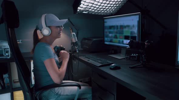 Beautiful Woman In A Cap And White Headphones Leads A Live Stream