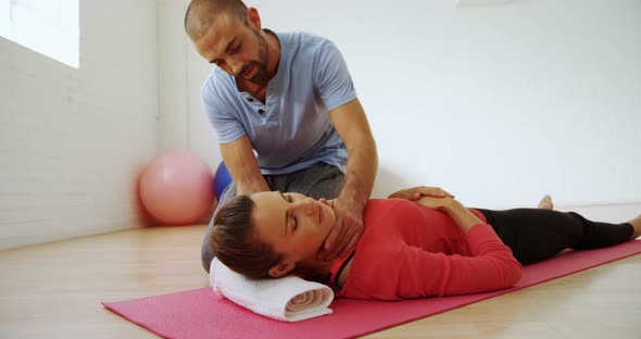 Coach Assisting a Woman in Fitness Studio 4k