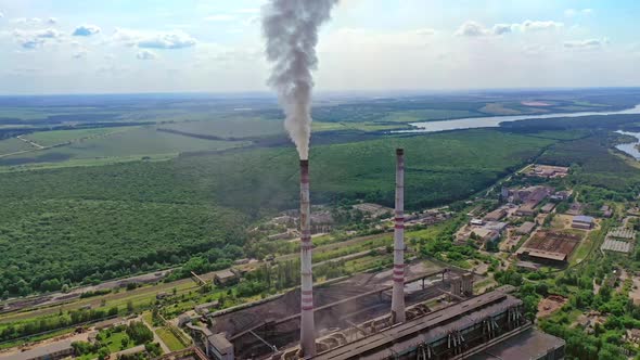 Industrial area in nature. Industrial pipes with smoke. 