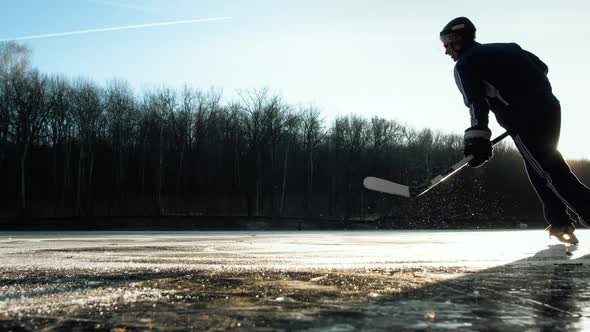 Hockey Player on Frozen Lake Make Ice Sparkles on High Speed Braking.hockey Stick in Hands, Canadian