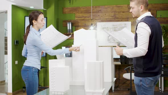 Team of Architect Working on a Building Project with Building Models